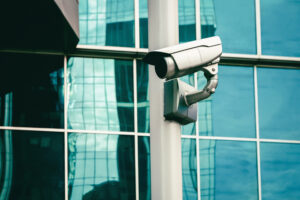 cctv camera - surveillance camera outside of glass building wall