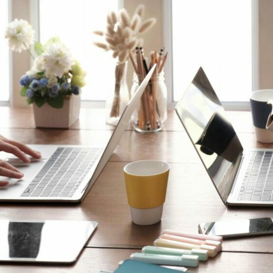 two-people-working-together-at-a-table-free-photo