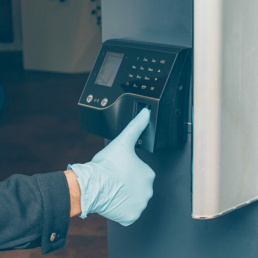 man-getting-intercom-read-his-fingerprint-open-door-with-gloves